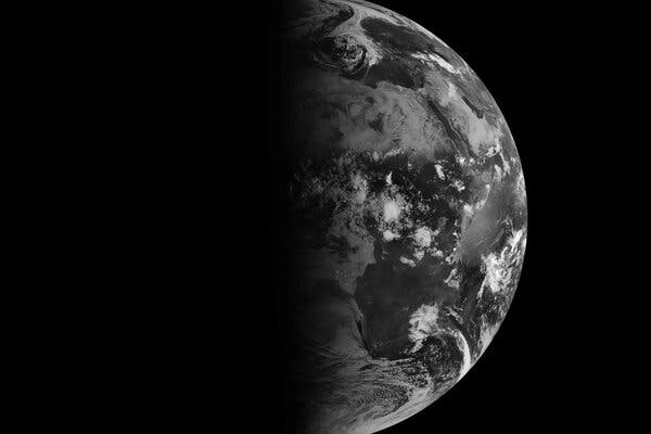 A black-and-white satellite view of the Earth at equinox.